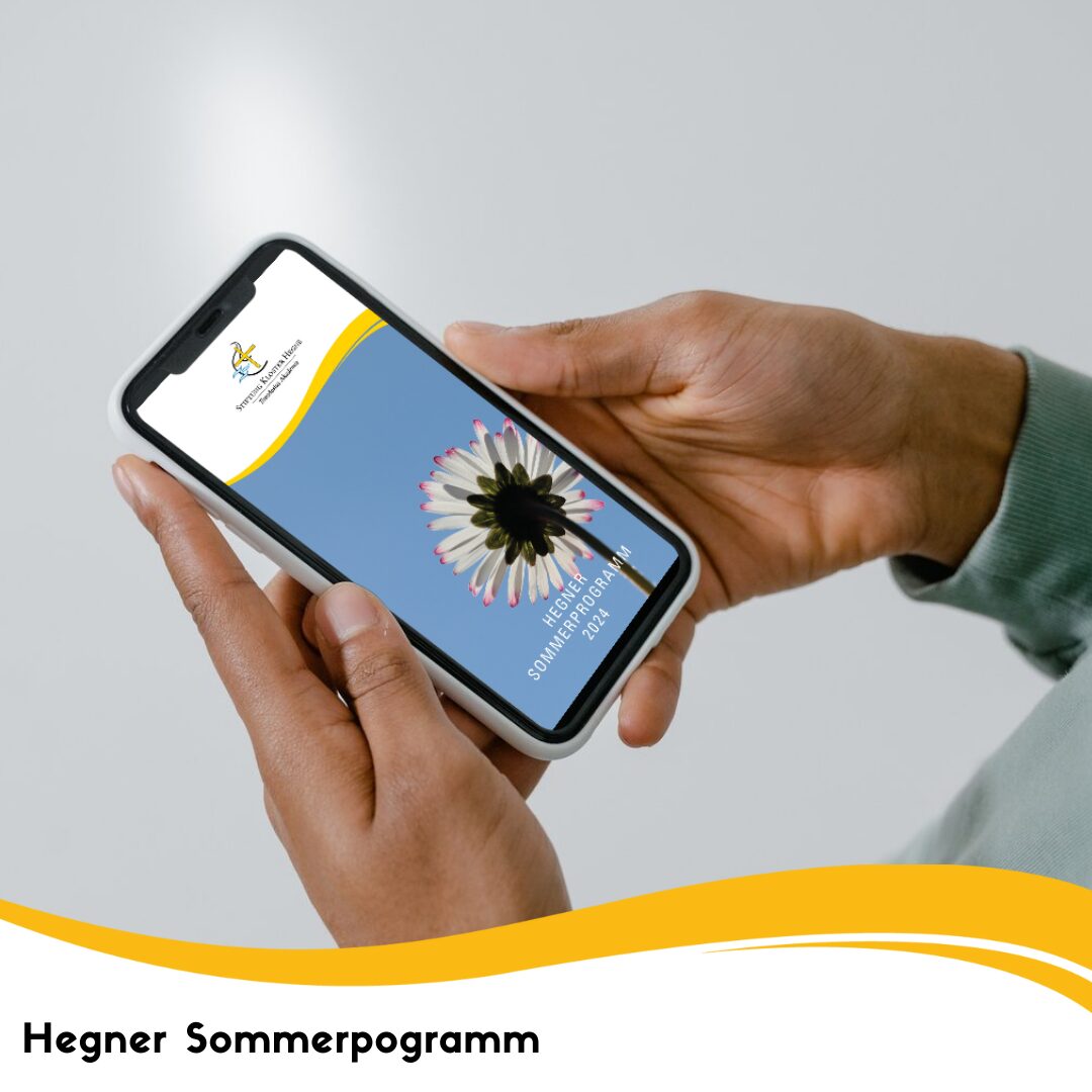 Ein Smartphone mit dem Hegne Sommerprogramm 2024 geöffnet wird von einer Person in der Hand gehalten.